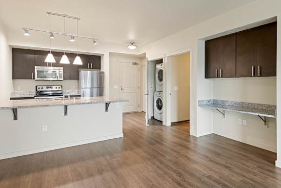 A kitchen with a stove top oven and a refrigerator.