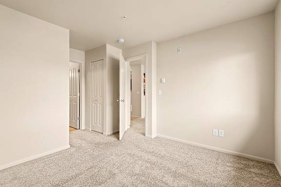 A room with carpeted floor and white walls.