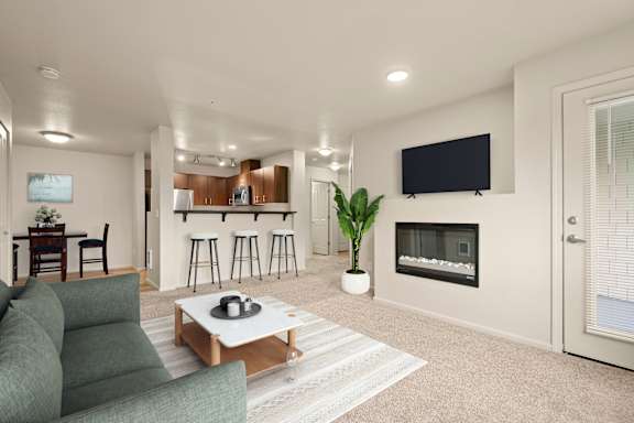 A modern living room with a fireplace and a flat screen TV.