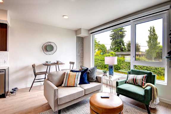 Open concept living & dining, with large windows.