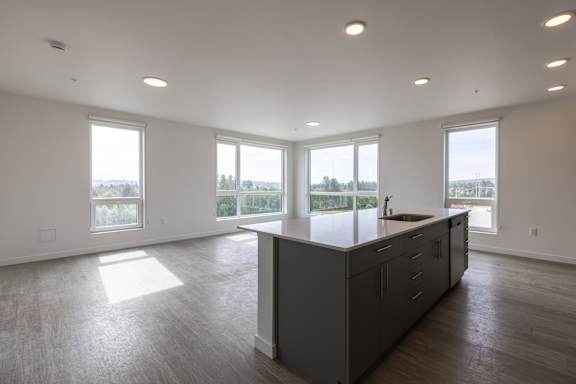 Open concept kitchen and living area with large windows 7 at Riverfront Everett Apartments, Everett, WA 98201