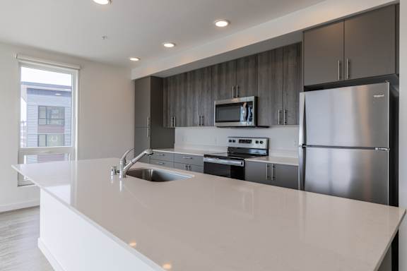 Modern kitchen with stainless steel appliances 7 at Riverfront Everett Apartments, Everett, WA