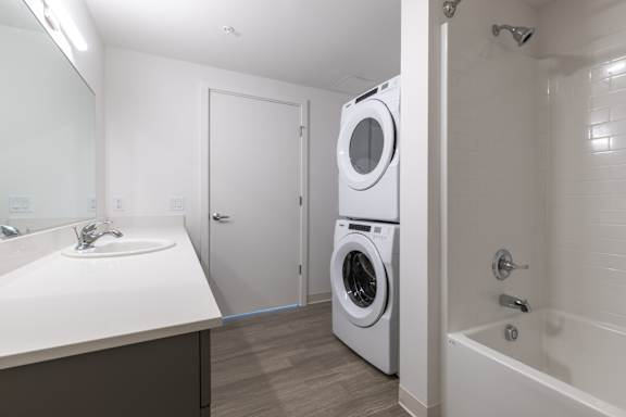 Bathroom with stacked washer and dryer 7 at Riverfront Everett Apartments, Everett