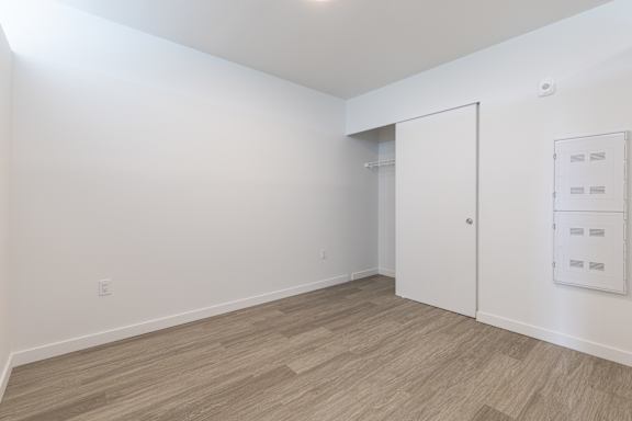 A room with a white door and a white wall.