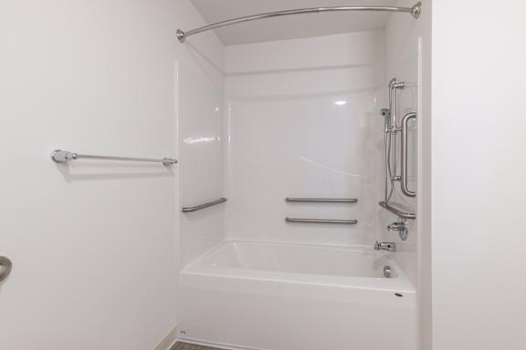 A white bathroom with a tub and shower.