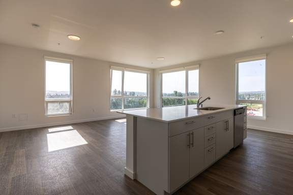 A kitchen with a sink and cabinets is shown in the image.