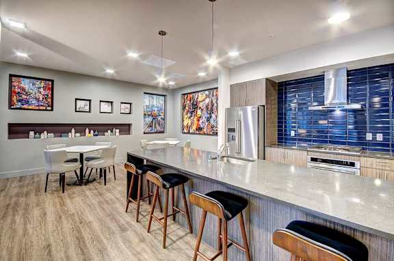 A kitchen with a bar area and a dining table.