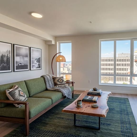 A living room with a green couch and a coffee table.