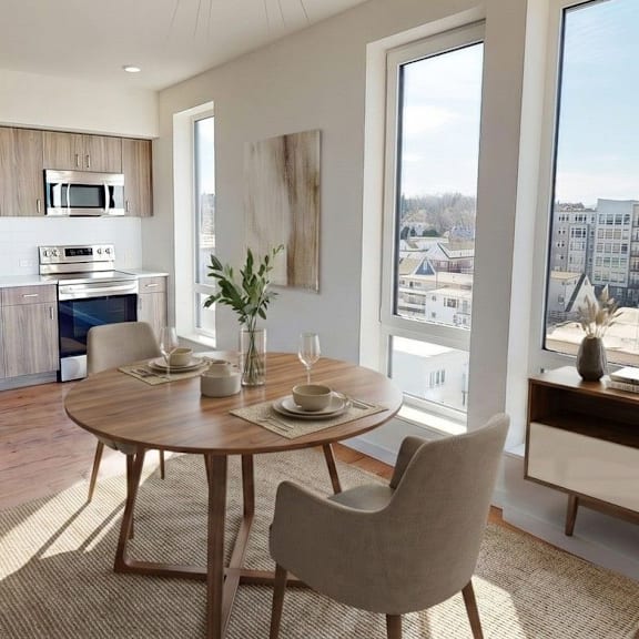A modern dining room with a round wooden table and chairs.