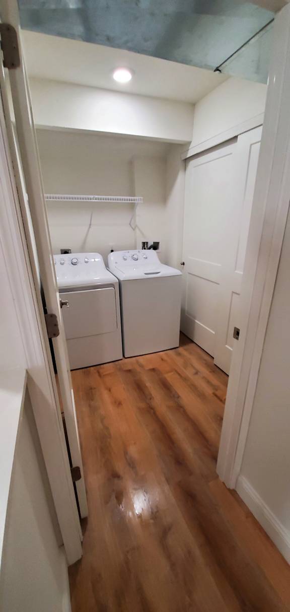 A small laundry room with a washer and dryer.