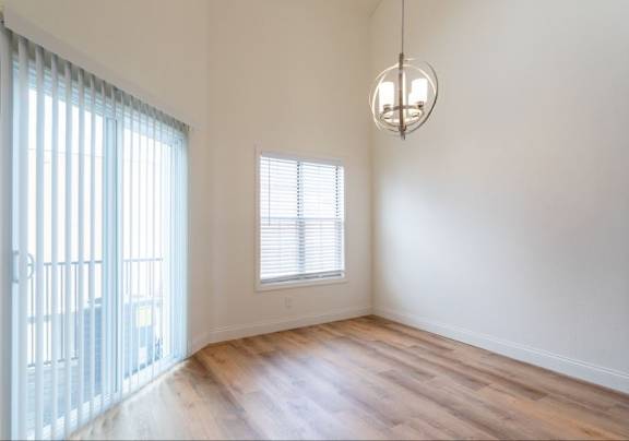 A room with a window and a hanging light fixture.