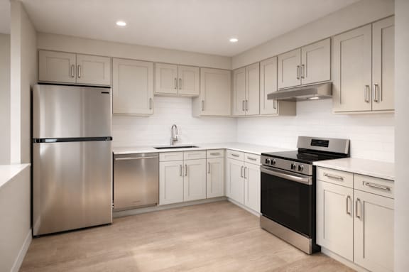 A modern kitchen with stainless steel appliances and white cabinetry.