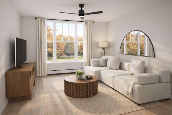 A living room with a white couch, a wooden coffee table, and a flat-screen TV.