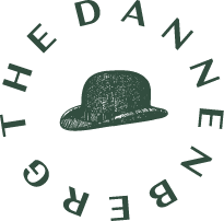 A green hat is in the middle of a circle of text that reads "The Danzene".