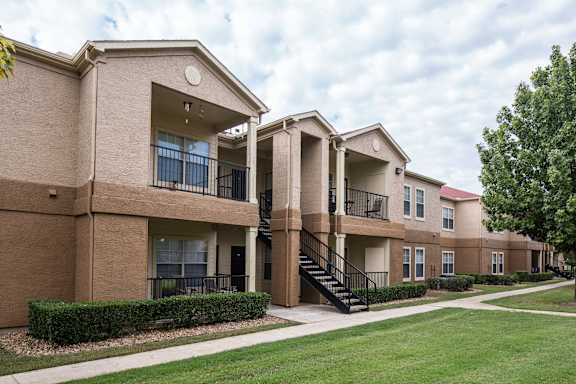 Apartment complex with a green lawn in front at Infinity on Sunnyvale Apartments , Mesquite, TX, 75150