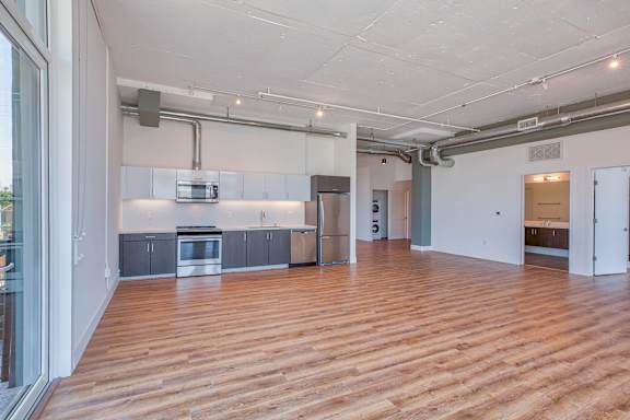A kitchen area with wooden floors and a white ceiling.at 2231 S Western, Los Angeles California