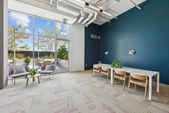 A room with a long table and chairs with a view of the outside.at 2221 S Western, Los Angeles, CA