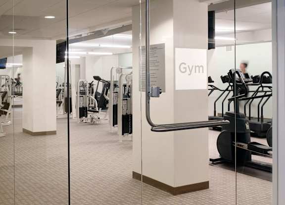 A gym with treadmills and other equipment.