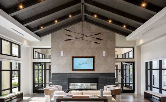 A modern living room with a fireplace at Las Palmas Apartments, Fort Myers, Florida