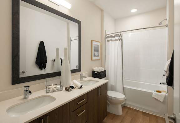 A bathroom with a white sink, toilet, and bathtub.