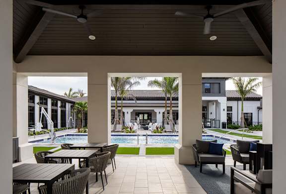 A patio with a table and chairs at Las Palmas Apartments, Fort Myers, FL