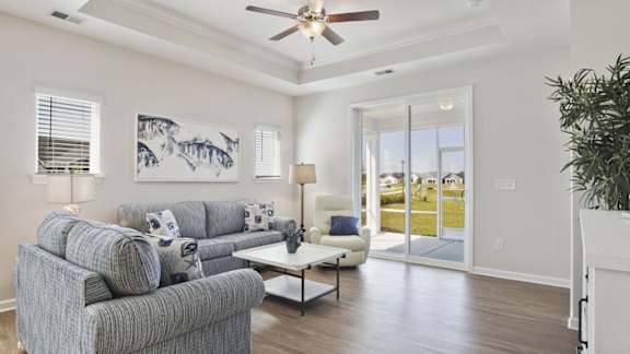 A living room with a grey couch and a painting on the wall at Stepping Stone at Bridgewater Apartments, South Carolina