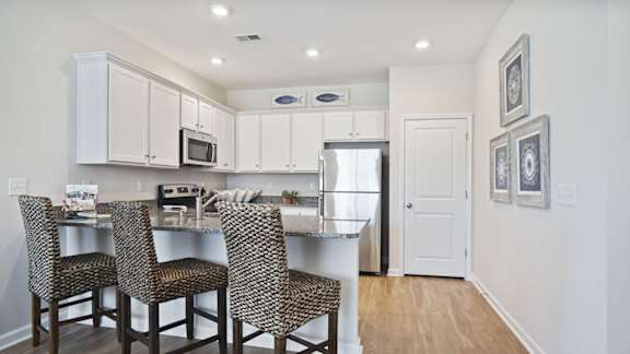A kitchen with a table and chairs at Stepping Stone at Bridgewater Apartments, South Carolina