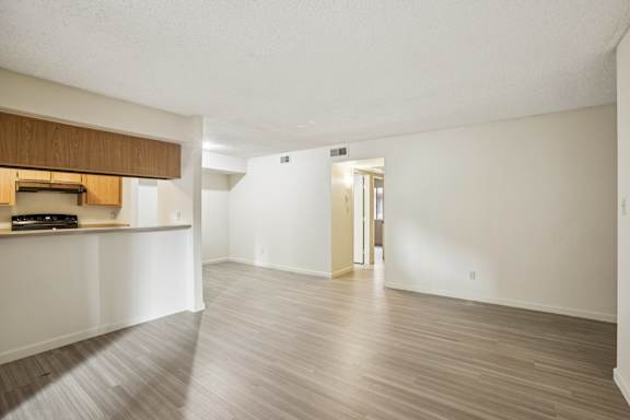 A room with wooden floors and white walls.