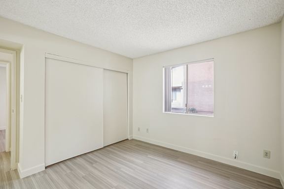 A room with a window and a sliding door.