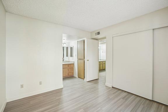 A room with a white wall and a wooden floor.