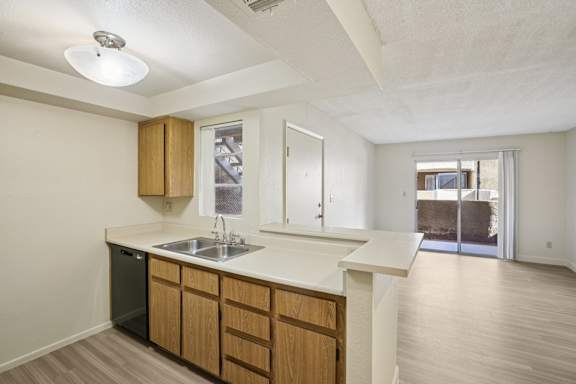 A kitchen with wooden cabinets and a white countertop.