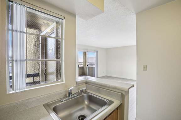 A kitchen with a sink and a window.