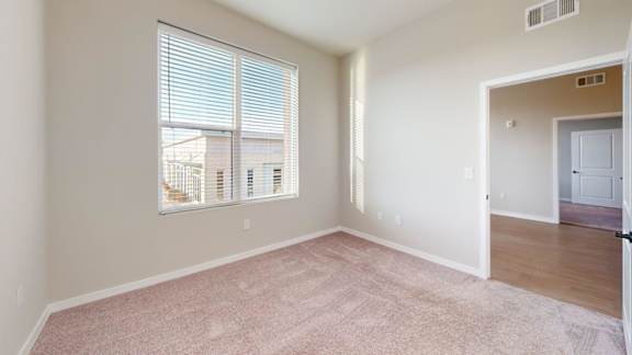 A room with a window and a door.
