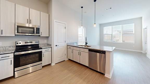 A kitchen with white cabinets and stainless steel appliances.