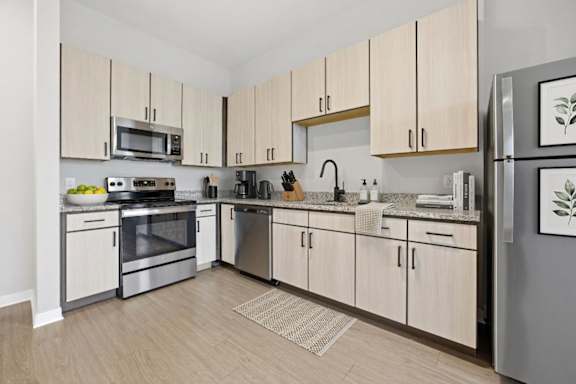 A kitchen with wooden cabinets and stainless steel appliances.