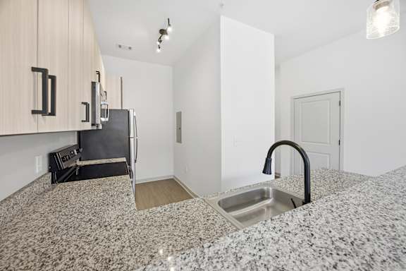 A kitchen with granite countertops and a sink.