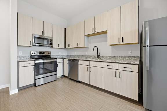 A kitchen with wooden cabinets and stainless steel appliances.