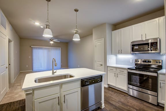 A kitchen with white cabinets and stainless steel appliances.