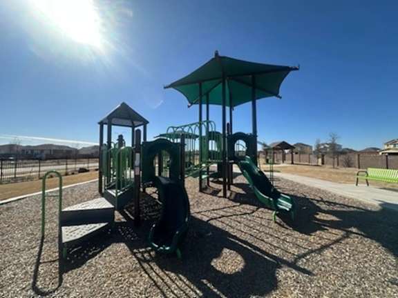 Playground with a Green Canopy at Cottages at Beltmill Apartments, Saginaw, Texas