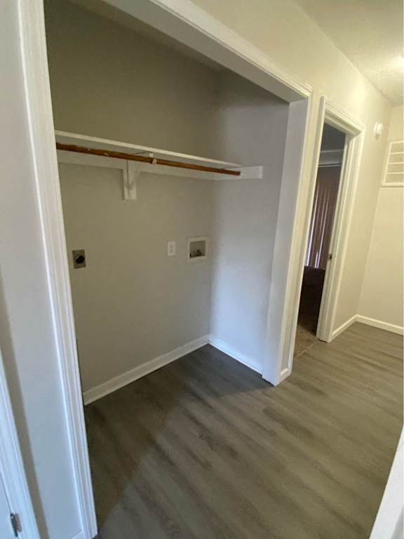 a hallway with wood floors and a closet