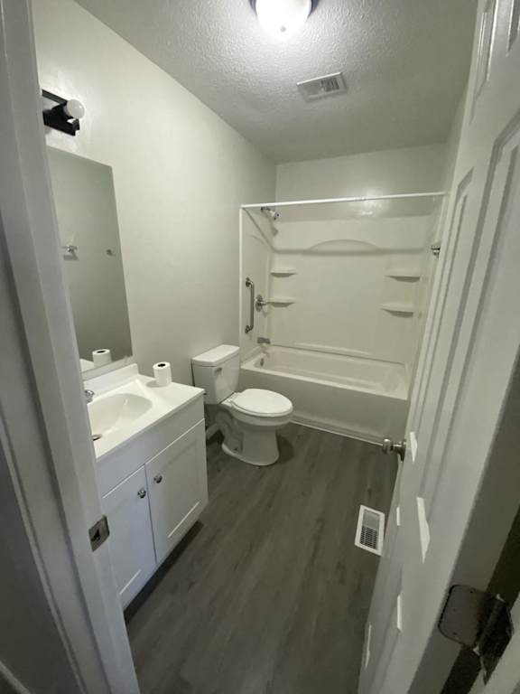 a white bathroom with a toilet and a sink