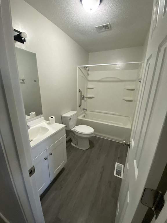 a white bathroom with a toilet and a sink