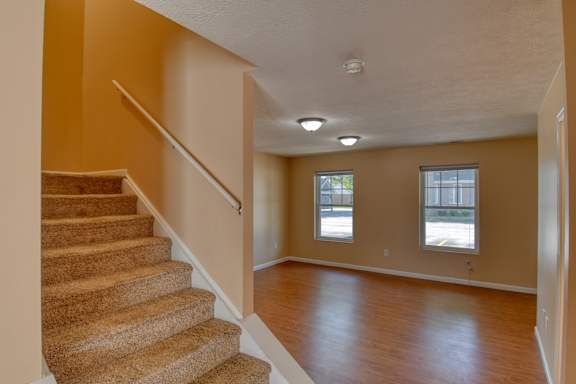 A room with a staircase and a window.