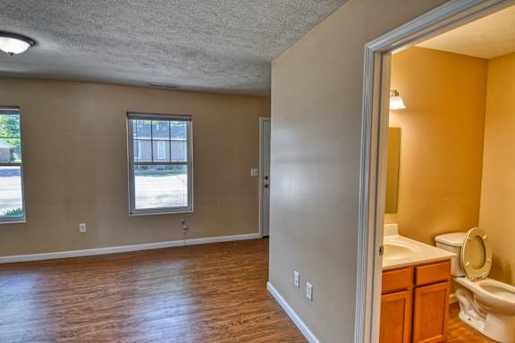 A room with a window and a toilet.