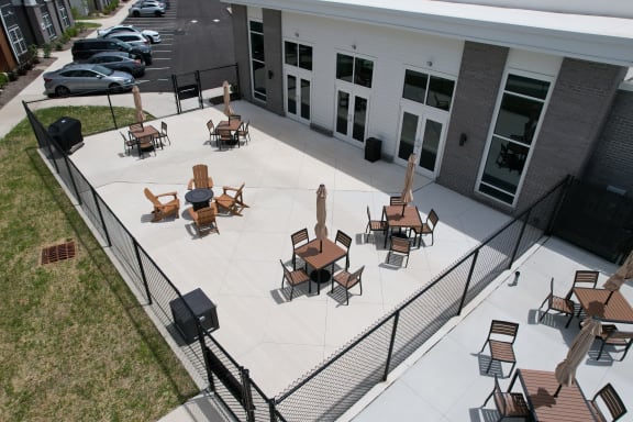 Patio with tables and chairs at The Landing Apartments, Avon, IN