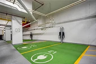 Parking garage with electric vehicle charging stations at Citizen on Jasper, Edmonton, AB, T5K 0M5