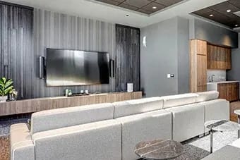 Modern living room with flat screen TV at Citizen on Jasper, Edmonton, AB, T5K 0M5