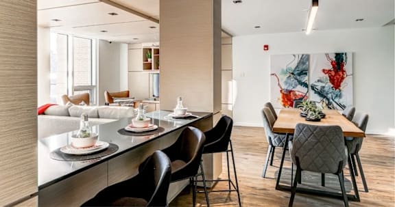 A modern dining room with a long table at Southpark on Whyte, Edmonton, T6E 3S3