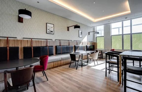 Room with tables and chairs and a long bench at Citizen on Jasper, Alberta, T5K 0M5