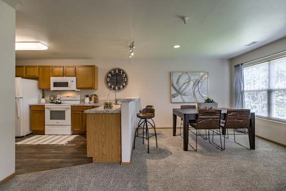 A kitchen with a dining table and chairs. at Tranquility Pointe, Omaha